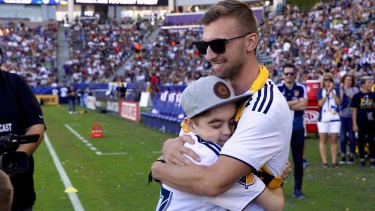 Seth Akins, 11, of Rancho Cucamonga, greets his bone marrow donor, Aaron Allen 23, of Long Beach, for the first time during halftime at the LA Galaxy game on Sunday, Sept. 23.