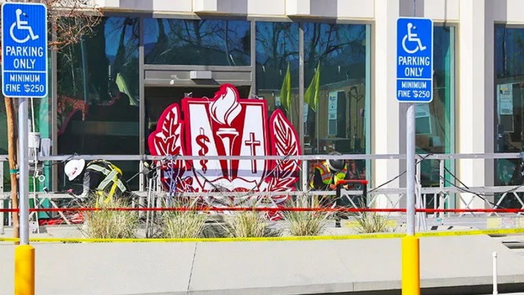 Workers prepare to raise a large version of the Loma Linda University Health logo to be installed on the top of the future Adult tower. Logo installed on Adult Tower