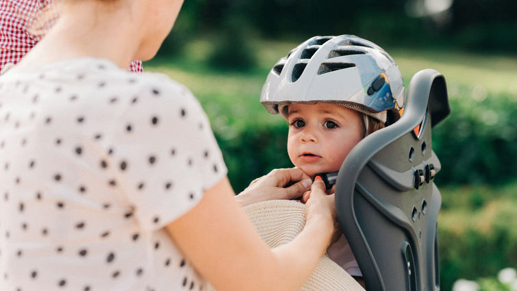 baby safely fastened into baby seat