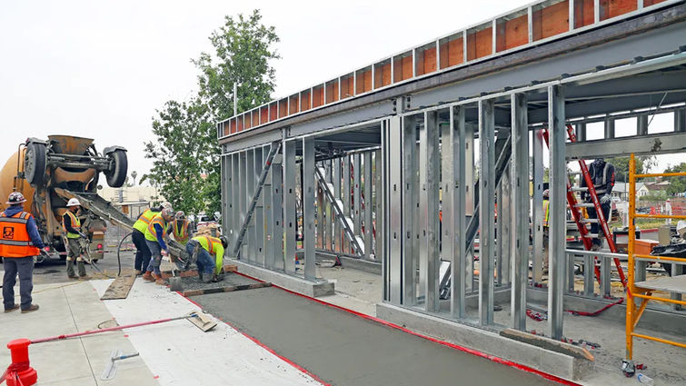 Concrete finishing work around the base of the future valet parking building nears completion. Valet parking building nears completion