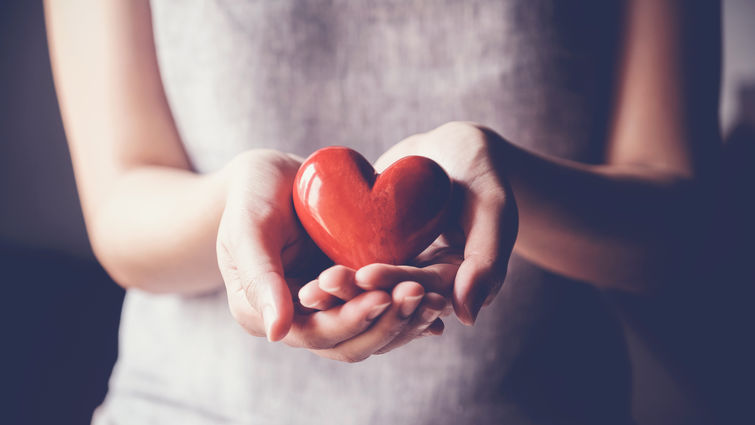 woman holding a heart shape in her hand