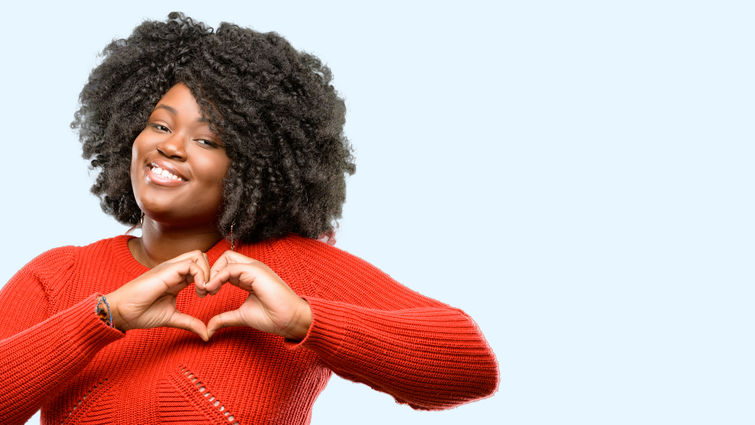 women creating a heart with her hands