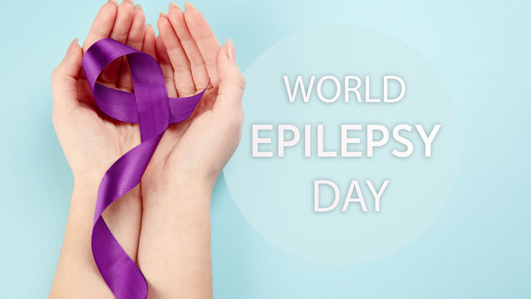 hands with purple ribbon honor world epilepsy awareness day