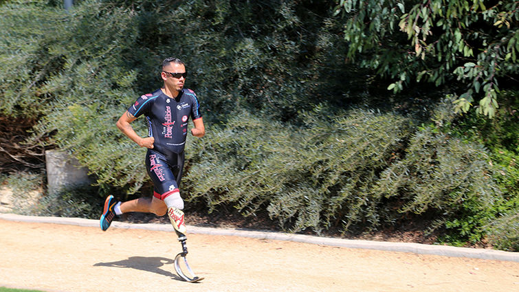 Zimri Solis pushes himself on the track to demonstrate that limb loss need not deter anyone from an active lifestyle.