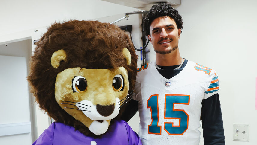 NFL Miami Dolphins linebacker Jaelan Phillips takes photos with Luke the Lion during his visit to Loma Linda University Children’s Hospital