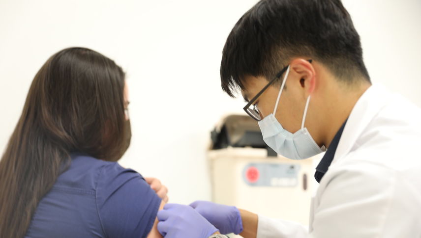 Doctor preps a patient for a flu vaccine 