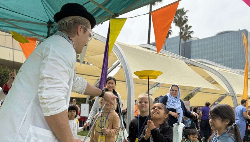 Young kids learn how to balance plates with red nose docs