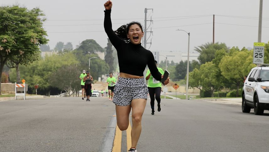 Woman celebrating at 5k finish line