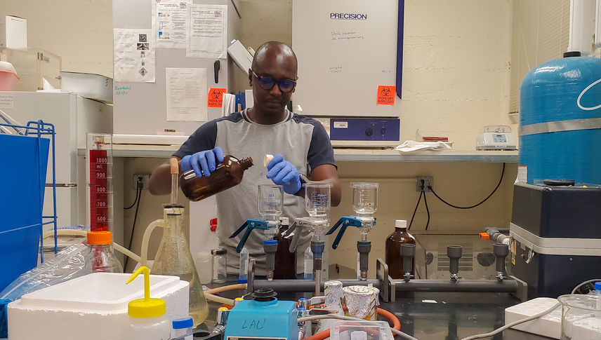 Thomas Hile, PhD, MSc, an LLU affiliated researcher, prepares water samples for testing in a laboratory.