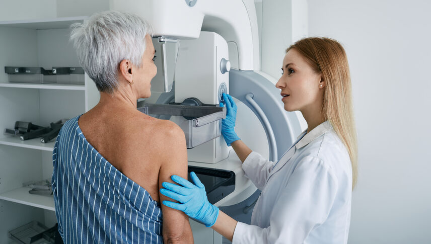  Senior woman having mammography scan at hospital with medical technician