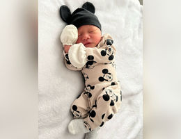 Newborn baby sleeping on bed