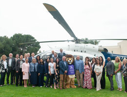 LLUH Administration and staff stand in front of new helicopter