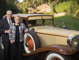 From left, Carlton and Raye Lofgren stand outside their Riverside home with the Cord L29 that they recently donated to LLU Children’s Hospital and entered into the Barrett-Jackson car auction happening Jan. 21.