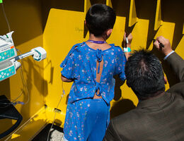 Pete Aguilar signing a pedestal with a patient