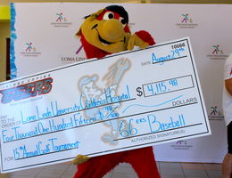 IE 66ers team mascot, Bernie, shows off the check he and members of the team presented to LLUCH on Tuesday, August 29.
