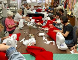 Volunteers work diligently at Redlands Sewing Center on June 10 to create 200 stockings for the Total Care Birth Center at LLUCH.