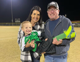 Lisa Cummings and her husband hold their grandson after his soccer match.