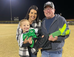 Lisa Cummings and her husband hold their grandson after his soccer match.
