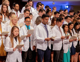 first-year medical students stand on the church steps to recite oath