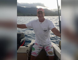 James Ryan sitting on a boat smiling