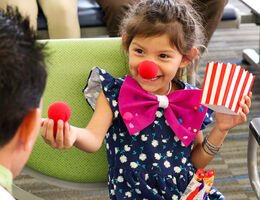 little girl with red nose and popcorn