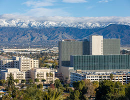 scenic view of hospital and snow-capped mountains in background