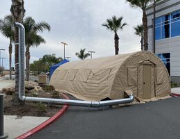 tan medical tent next to hospital 