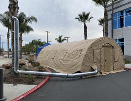 tan medical tent next to hospital 