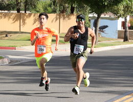 Two men running to the finish line at the Stand Up to Stigma 5K