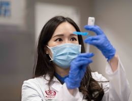 LLU health worker prepares to inject a dose of the COVID-19 mRNA vaccine.