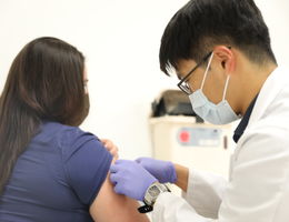 Doctor preps a patient for a flu vaccine 