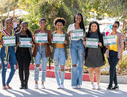 Nine students hold up signs stating where they matched for their residency