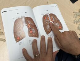 a man points to a picture of lung