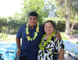 Son and his mother standing together to pose for camera
