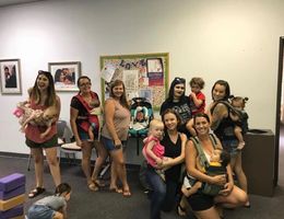 Moms gathered in class posing for birth and beyond support group photo