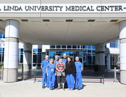 Dr. Parekh, Rickey Rodroguez, and the TARV team standing outside the Loma Linda Medical Center Murrieta