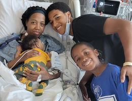 LaCresha Bell at Loma Linda University Medical Center, surrounded by family (her two sons and younger brother).