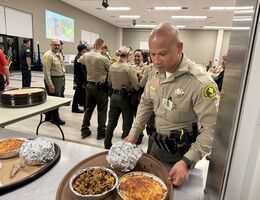 San Bernardino County Sheriff's deputies volunteered as waitstaff, collecting tips that were donated back to LLUCH Sheriif's deputy serving food at event