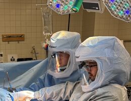 Dr. Hudson performs a hip surgery in a hospital with another doctor