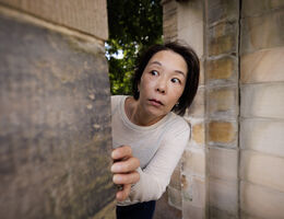 Woman peeking around corner