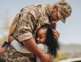 Emotional soldier hugging his daughter - stock photo