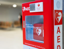 An Automated External Defibrillator, (AED) placed on the wall in public locations.