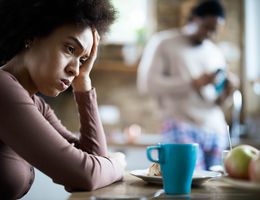 Displeased black woman having problems during morning in the kitchen. - stock photo