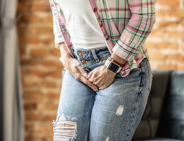 woman trying to hold pee