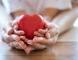 Woman and child holding red heart