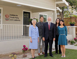 Members of the Institute for Health Policy and Leadership stand in front of the office