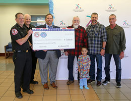 Monies raised by the Loma Linda and Colton fire departments and Quaid Harley-Davidson will benefit patients of Loma Linda University Children's Hospital like the boy in the foreground.