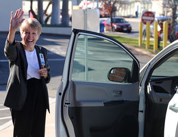 Mary Clement's smile reflects her exuberance over the Department of Public Affairs' new van.