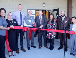 Officials of Loma Linda University Health and political and community leaders getting ready to cut the ribbon at the grand opening for Digital Production Ink.