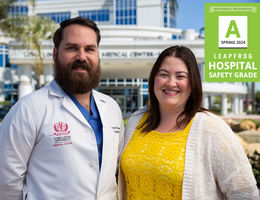 LLUMC-Murrieta employees, Garrett Newman, MSN, FNP-C, RNFA, CNOR, (left) a nurse practitioner in the Department of Surgery and Vascular Surgery, and Clinical Coordinator for Surgical Services; and Jennifer McMahon, DNP, A-GNP-C, OCN, CMSRN, an oncology nurse navigator. Brown-haired Caucasian male with a beard wearing a white coat standing next to a brunette in a yellow blouse outside